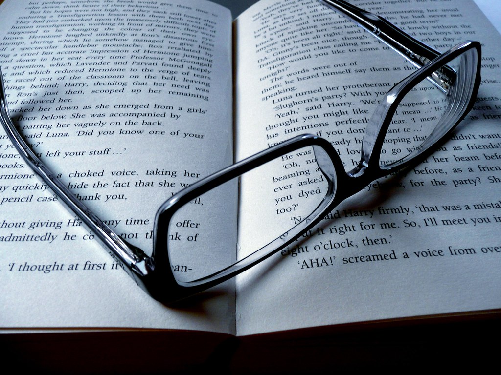 Eyeglasses resting on an open book